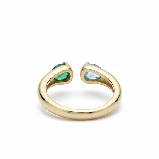 Anillo abierto Ámbar Joyas en tono dorado con circonitas verde esmeralda y azul celeste en diseño de doble gota