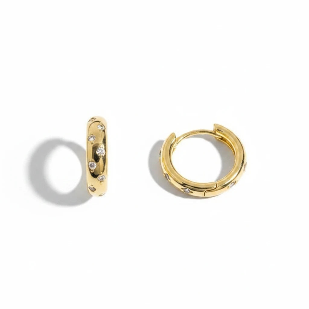 Aros huggie Ámbar Joyas en baño de oro 18k con circones incrustados, diseño minimalista y elegante.